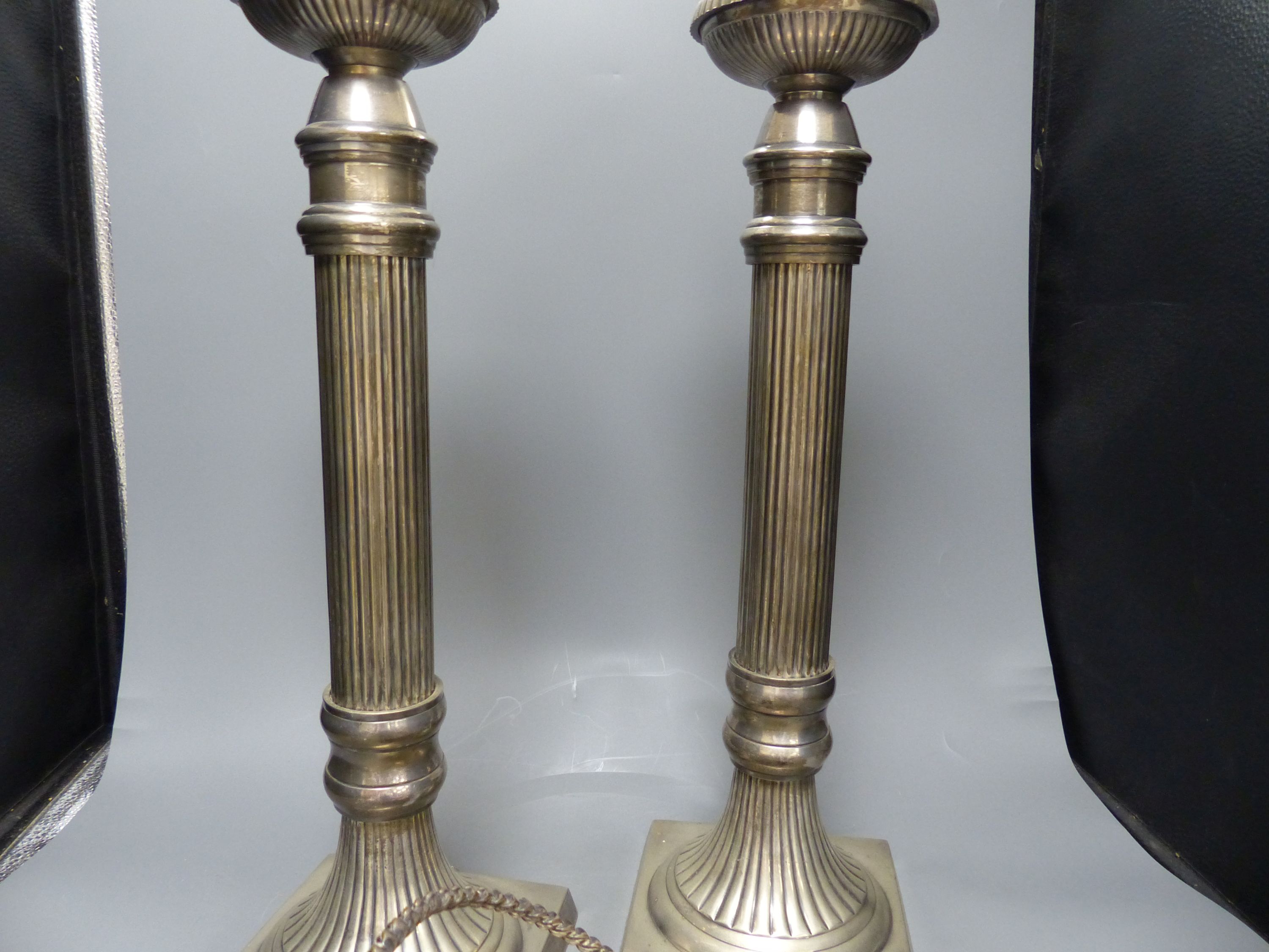 A pair of large plated electric table lamps, each square base marked AWEP, and a plated cake basket